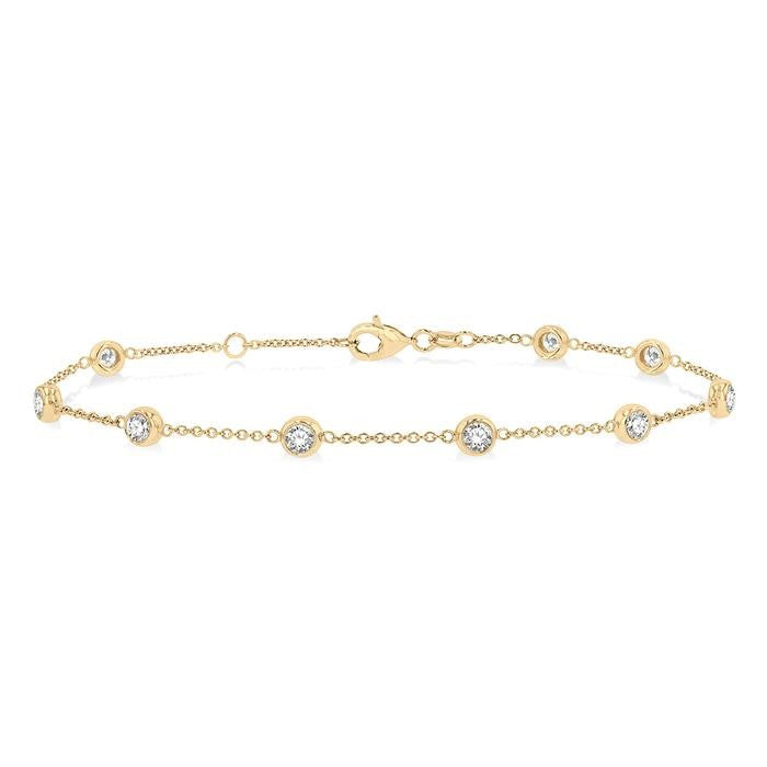 Gold bracelet with diamond accents on a white background